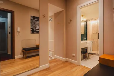 a hallway with a bathroom with a sink and a mirror at Vicario Suites in Rome