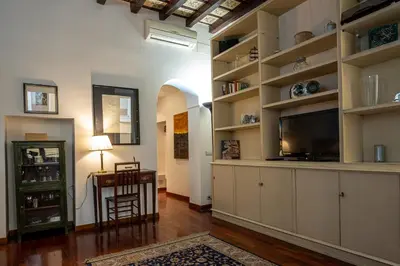 a living room with a flat screen tv and shelves at Appartamento Margherita 2 in Rome