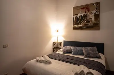 a bedroom with a bed with towels on it at Appartamento Margherita 2 in Rome