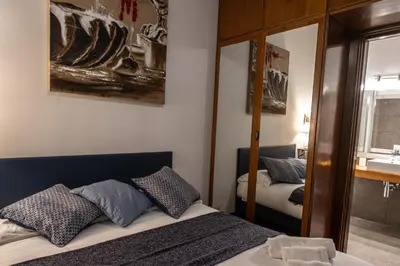 a bedroom with a bed and a mirror and a sink at Appartamento Margherita 2 in Rome