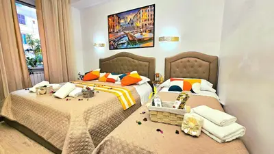 a bedroom with two beds and a painting on the wall at A Casa Simpatia in Rome