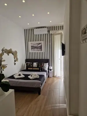 a bedroom with a bed with two towels on it at Home K&Y - Aurelio in Rome