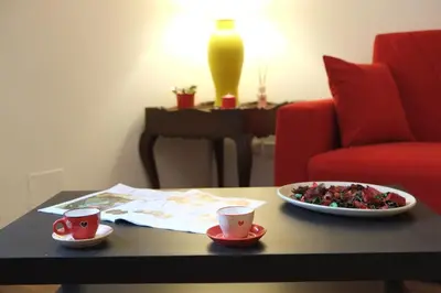 a table with two cups and a plate of food at Trastevere Sweet Home in Rome
