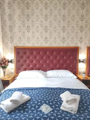 a bedroom with a large bed with two pillows on it at A&C Much More II in Rome