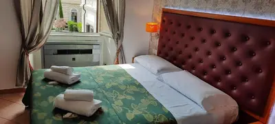 a bedroom with a bed with two towels on it at A&C Much More II in Rome
