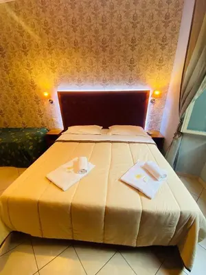 a bedroom with a bed with two towels on it at A&C Much More II in Rome