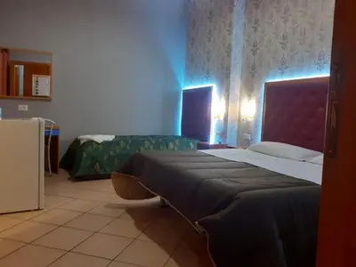 a hotel room with two beds and a refrigerator at A&C Much More II in Rome