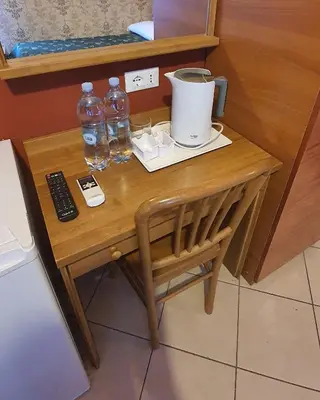 a table with two bottles of water and a drink at A&C Much More II in Rome