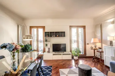 a living room with a table and a television at FRESH HOUSE MONTI in Rome
