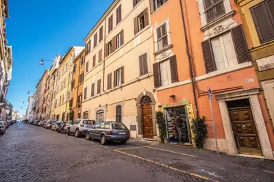 a city street with cars parked next to buildings at FRESH HOUSE MONTI in Rome