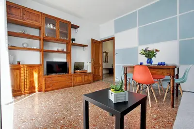 a living room with a table and a tv and a desk at Martino Delightful Apartment in Rome