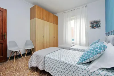 a bedroom with two twin beds and a window at Martino Delightful Apartment in Rome
