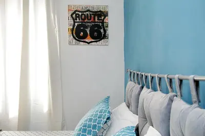 a bedroom with blue walls and a bed with pillows at Martino Delightful Apartment in Rome