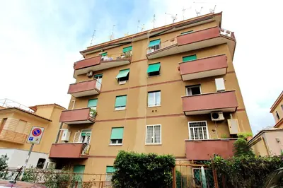 a tall building with balconies on the side of it at Martino Delightful Apartment in Rome