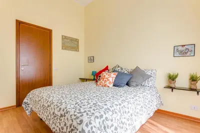 a bedroom with a bed with pillows on it at St. Joseph Apartment 47 in Rome