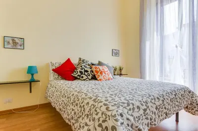 a bedroom with a bed with pillows and a window at St. Joseph Apartment 47 in Rome