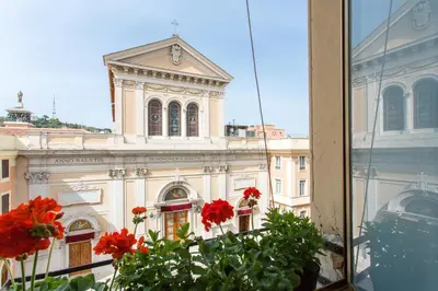a view of a building with a clock tower from a window at St. Joseph Apartment 47 in Rome