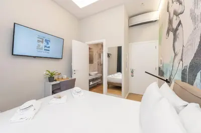 a bedroom with a bed and a tv on the wall at B-STAY Via Milano 52 in Rome