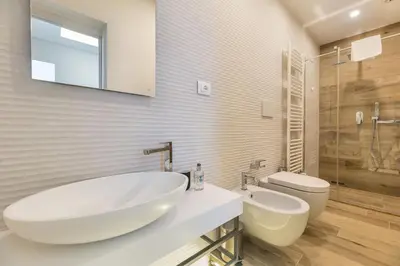 a bathroom with a large white sink and a toilet at B-STAY Via Milano 52 in Rome