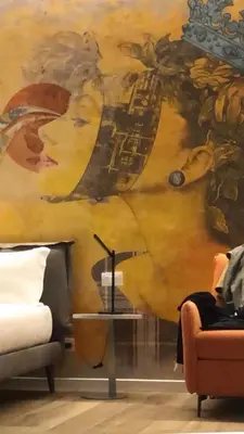 a room with a painting of a woman on the wall at B-STAY Via Milano 52 in Rome