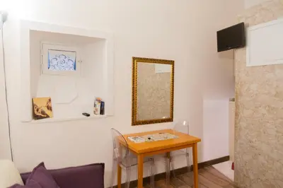 a room with a table and a mirror on the wall at Il Rifugio di Trastevere in Rome