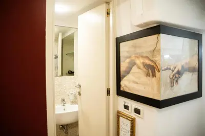 a bathroom with a painting on the wall next to a sink at Il Rifugio di Trastevere in Rome