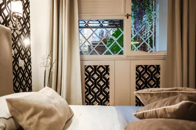 a bedroom with a window and a bed with pillows at EBL LUXURY HOME in Rome