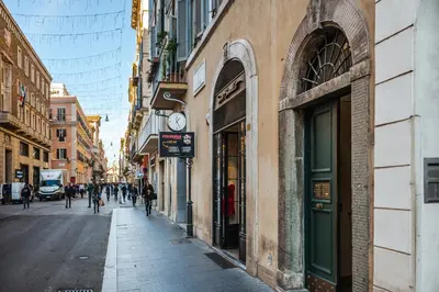 a street with a clock on the side of a building at EBL LUXURY HOME in Rome