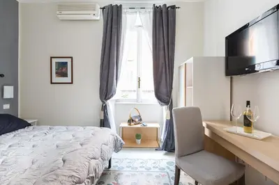 a bedroom with a bed and a desk with a computer at B&B Calamatta in Rome