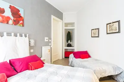 a bedroom with two beds with red pillows on them at B&B Calamatta in Rome