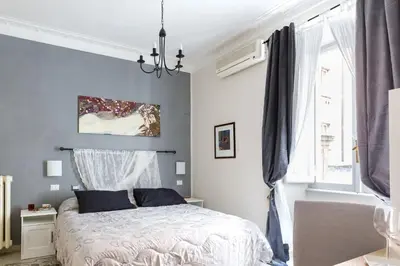 a bedroom with a bed with a blue wall at B&B Calamatta in Rome