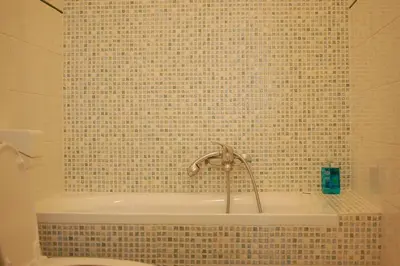 a bathroom with a bath tub with a sink at Moshi Moshi in Rome
