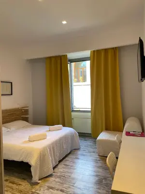 a bedroom with two beds and a window at Moshi Moshi in Rome
