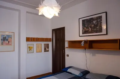 a bedroom with a bed and a chandelier at Appartamento 2 in centro a Roma in Rome