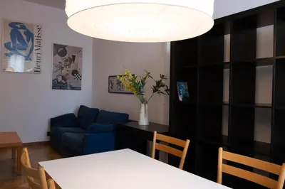a living room with a table and a blue couch at Appartamento 2 in centro a Roma in Rome