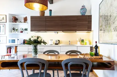 a kitchen with a wooden table and chairs at Arc Trilussa 44 in Rome