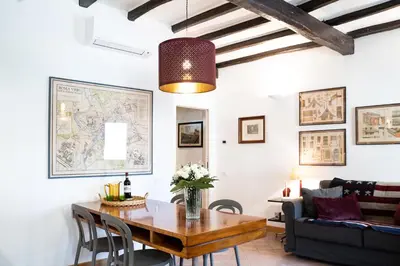 a living room with a table and a couch at Arc Trilussa 44 in Rome