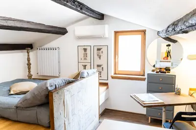 a bedroom with a bed and a desk and a table at Arc Trilussa 44 in Rome