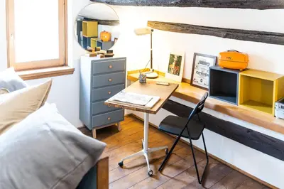 a desk in a bedroom with a bed and a desk with a chair at Arc Trilussa 44 in Rome
