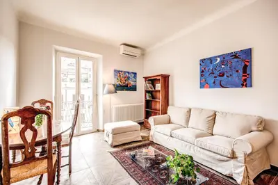 a living room with a couch and a table at Cavour Attic with terrace in Rome
