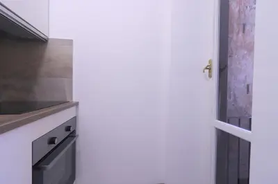 a kitchen with a white door and a counter at Lovely Navona Apartment in Rome