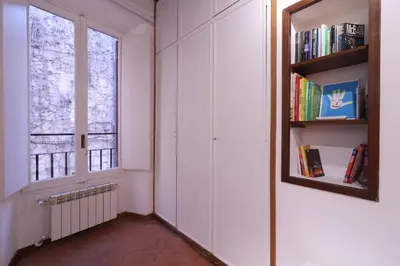 a room with a window and a book shelf at Lovely Navona Apartment in Rome
