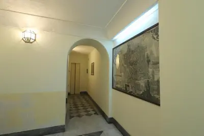 a hallway with a large painting on the wall at Lovely Navona Apartment in Rome