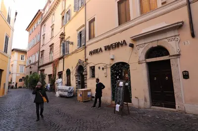 a couple of people walking down a street at Lovely Navona Apartment in Rome