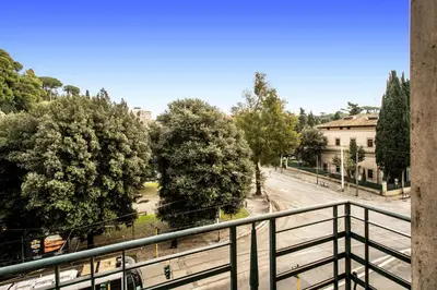 a view of a city street from a balcony at DOWNTOWN SRL - Borghese Green in Rome