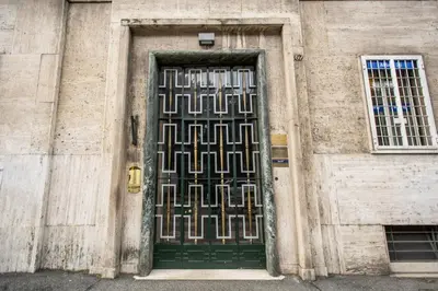 a green door on the side of a building at DOWNTOWN SRL - Borghese Green in Rome