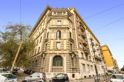 a large building with cars parked in front of it at DOWNTOWN SRL - Borghese Green in Rome
