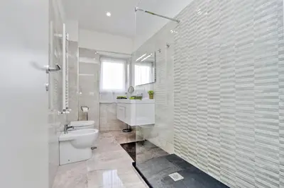 a white bathroom with a toilet and a sink at Maison Roberta San Peter in Rome