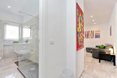 a white living room with a sink and a couch at Maison Roberta San Peter in Rome