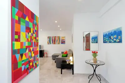 a living room with a colorful painting on the wall at Maison Roberta San Peter in Rome